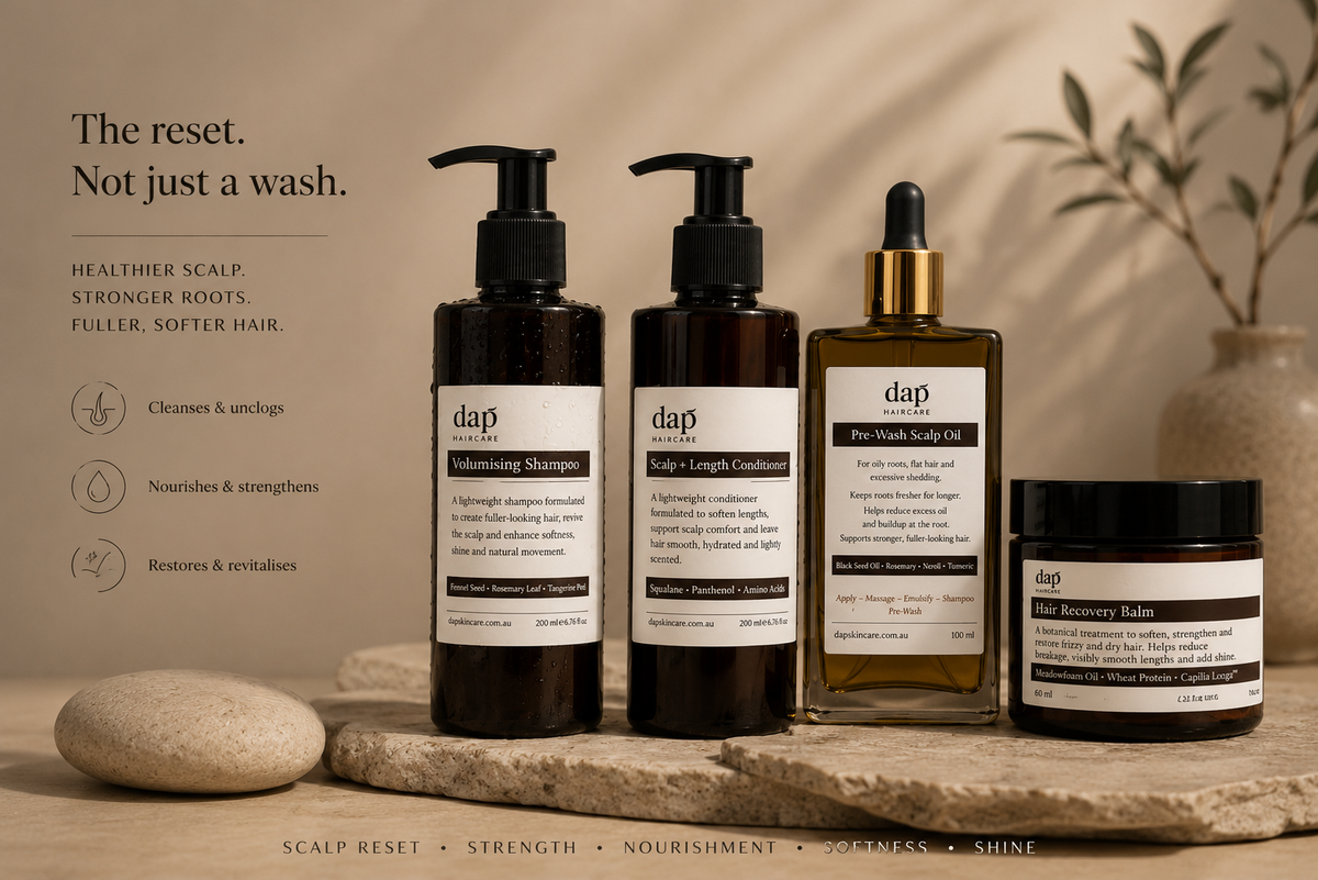 Set of DAP hair care products on a wooden surface with a neutral background