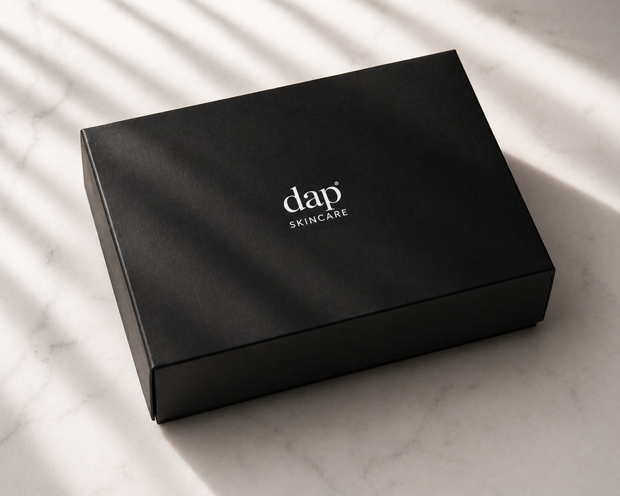 Black skincare product box with 'dap Skincare' branding on a marble surface.