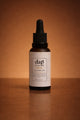 Bottle of dap skincare Nova Cleansing Oil on a brown background